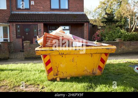 full skip outside a house in residential area home improvements Liverpool merseyside uk Stock Photo