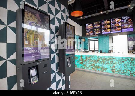 automatich touch screen ordering stations and empty customer counter taco bell kirkby Liverpool merseyside uk Stock Photo