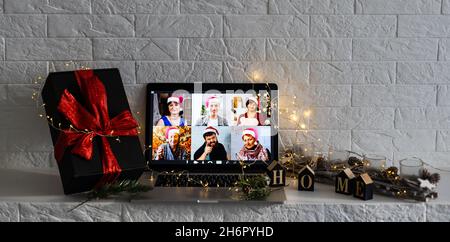 Christmas day Virtual meeting team teleworking. Family video call remote conference. Laptop webcam screen view. Diverse portrait headshots meet Stock Photo