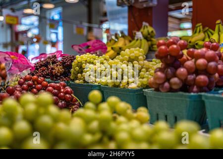 Selective focus shot of colorful grapes in a market at the Granville Island in Vancouver, Canada Stock Photo