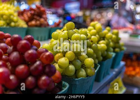 Selective focus shot of colorful grapes in a market at the Granville Island in Vancouver, Canada Stock Photo