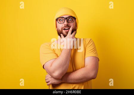 thinking man over yellow background, guy came up with a solution to the problem Stock Photo