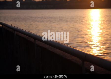The metallic baluster facing the Hudson river during a summer sunset in New York City Stock Photo