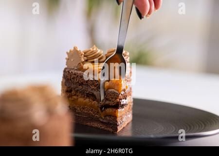 Delicious piece of cake on black plate. Stock Photo
