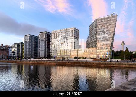 Early evening with the dramatic, funky, new, buildings at Liverpool One reflected in Canning Dock at Liverpool's historic Albert Dock. Stock Photo