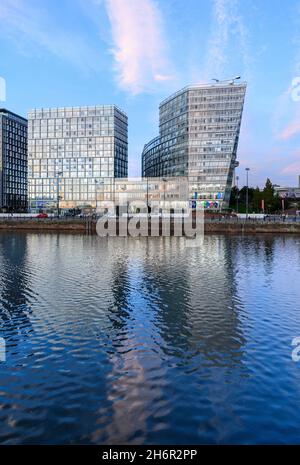 Early evening with the dramatic, funky, new, buildings at Liverpool One reflected in Canning Dock at Liverpool's historic Albert Dock. Stock Photo