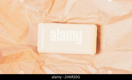 Bar of organic soap on crumpled brown wrapping paper Stock Photo
