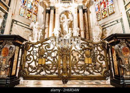 Carved gates with gilding in front of the altar of St. John in the Duomo. Milan, Italy Stock Photo