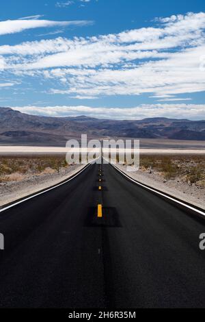 Perspective of straight highway heading towards horizon in the Panamint Valley in Death Valley National Park Stock Photo