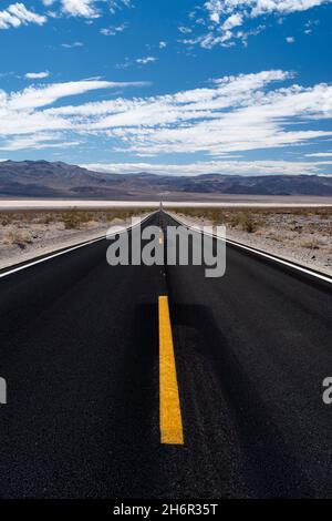 Perspective of straight highway heading towards horizon in the Panamint Valley in Death Valley National Park Stock Photo