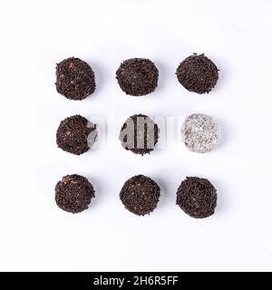 Sweet coconut and Swedish chocolate ball on white background. Selective focus. Stock Photo