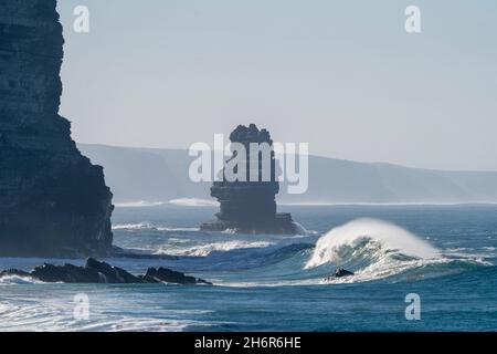 Perfect big wave breaking. Big surf near by the rocks in the sea. Powerful nature, ocean blue water Stock Photo