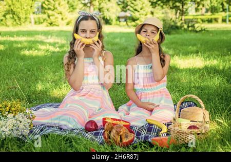 This banana wants you to be happy. Happy children have fun with banana. Picnic meal. Healthy nutrition. Benefits of fruit. Pediatric dentistry. Dental Stock Photo