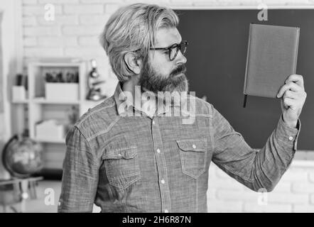 persistence concept. use notebook or book. back to school. literature and language learning. strict teacher in glasses. teacher check knowledge. are Stock Photo