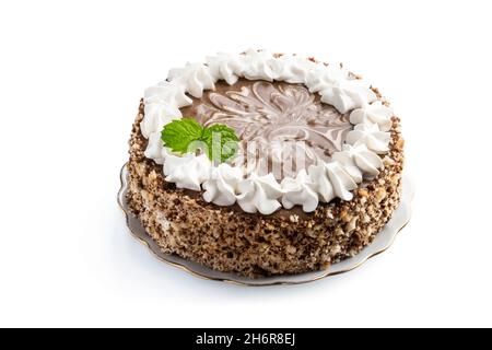 decorated  sponge cake with mint leaves with walnuts isolated on white background Stock Photo