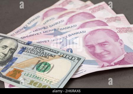 US dollars and Turkish Liras on top of each other completely covering the screen. 1 US dollar being equal to 10 Turkish Liras concept photo shoot Stock Photo