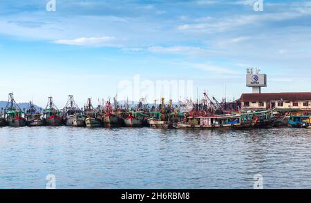 Kota Kinabalu, Malaysia - March 23, 2019: Fleet of fishing boats moored in port of Kota Kinabalu on a sunny day Stock Photo
