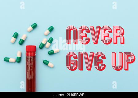 Hand writing sign Never Give Up. Business idea be persistent to keep on trying to improve the condition Prescribed Medicine Vitamines And Minerals Stock Photo