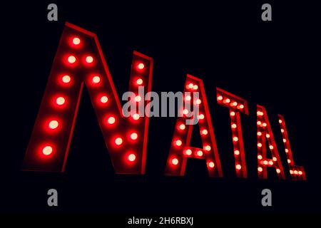 Christmas written in portuguese in 3D red lights. Christmas 3D background. Stock Photo