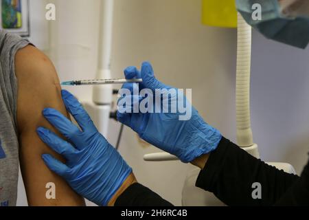 London, UK. 06th Nov, 2021. A NHS health worker administers the Pfizer/BioNTech Covid-19 booster jab to a woman at a vaccination centre as the NHS is preparing for a possible annual Covid-19 booster jabs programme. Credit: SOPA Images Limited/Alamy Live News Stock Photo
