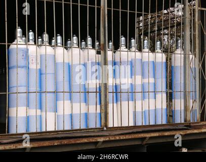 Cracow. Krakow. Poland. Oxygen cylinders with high pressured oxygen for medical purposes in locked cage outside the hospital. Stock Photo