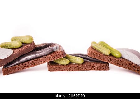Sandwich with fish and lightly salted cucumbers on black bread.  Stock Photo