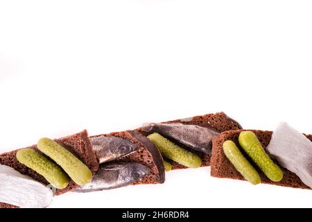 Sandwich with fish and lightly salted cucumbers on black bread.  Stock Photo