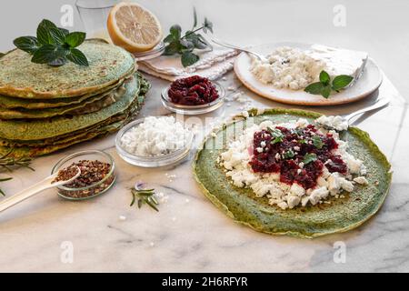 Close-up of pink pancakes with beetroot and feta, and green pancakes with spinach Stock Photo