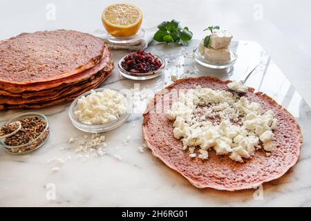 Close-up of pink pancakes with beetroot and feta Stock Photo