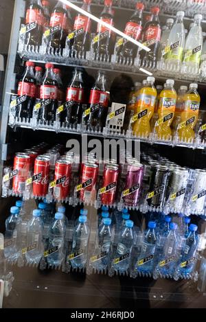 Warsaw, Poland - October 16, 2021: Cold drinks at the vending machine. Carbonated drinks in bottles and cans. Vending machine with carbonated drinks. Stock Photo