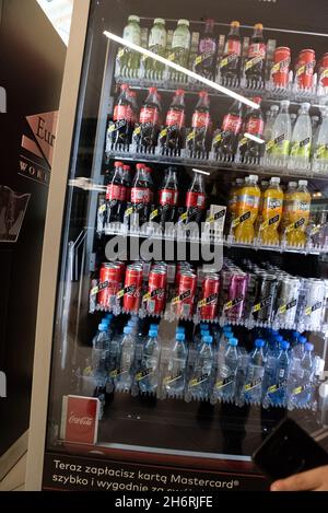 Warsaw, Poland - October 16, 2021: Cold drinks at the vending machine. Carbonated drinks in bottles and cans. Vending machine with carbonated drinks. Stock Photo