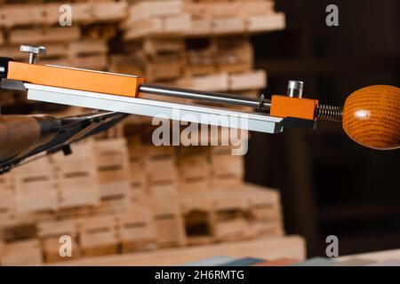 Sharpening knife process using professional sharpener with whetstone in workshop Stock Photo