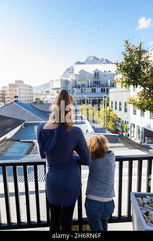children on balcony looking at Capetown, South Africa Stock Photo