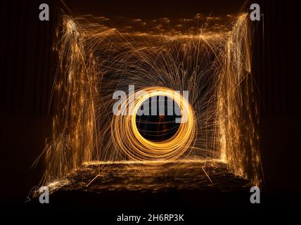 Scotland, United Kingdom, 17th November 2021. Light painting at night: the dark nights offer an opportunity to experiment with light painting by setting light to steel wool in a tunnel