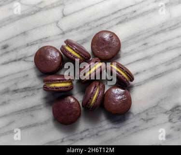 Passionfruit Macarons on White Marble Stock Photo