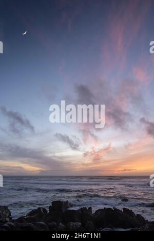 Moon over the Atlantic sea coast in Oia, Galicia Stock Photo