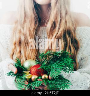 Gift box Christmas or New Year in the hands of a blonde woman. Stock Photo