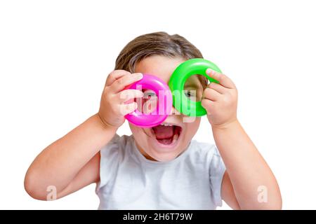 Child holds rings from toy pyramid as glasses isolated on white background Stock Photo