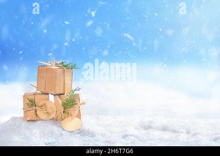 Christmas cardboard gifts boxes in snow on winter landscape Stock Photo