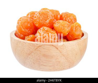 Dried prunes fruits (Preserved fruits Chinese plum) in wooden bowl isolated on white background, save clipping path. Stock Photo