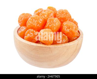 Dried prunes fruits (Preserved fruits Chinese plum) in wooden bowl isolated on white background, save clipping path. Stock Photo