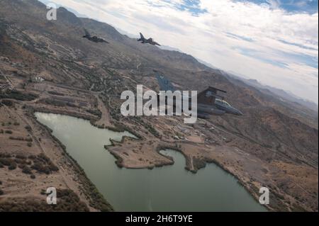 Three U.S. Air Force F-16 Fighting Falcons assigned to the 56th Fighter Wing, Luke Air Force Base, Arizona, fly over Phoenix during the NASCAR Cup Series Championship Nov. 7, 2021. The 56th and 944th FWs, which train U.S. Air Force F-16 pilots, conducted the flyover in support of the NASCAR championship race. Luke AFB continually bolsters partnerships with various organizations around Arizona, gaining support from the surrounding community. Stock Photo