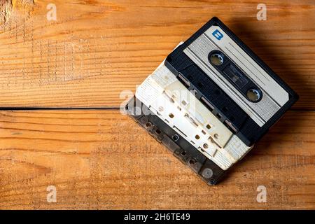 Old Audio Cassettes on a Wooden Planks Background closeup Stock Photo