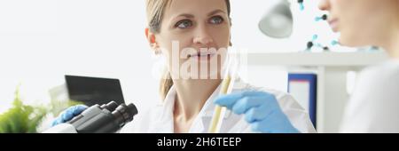 Two researchers conduct chemical tests on liquids in test tube Stock Photo
