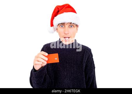 Surprised Young Man in Santa Hat with Empty Bank Card Isolated on the White Background Stock Photo
