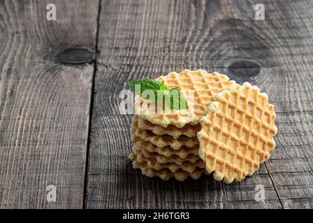 Round  Belgian waffles on rustic wooden table Stock Photo