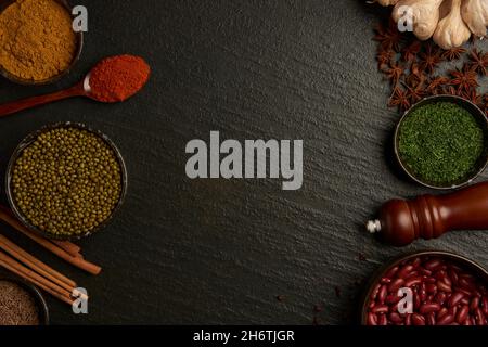 Various spices in wooden spoons on black background Stock Photo by  Prostock-studio