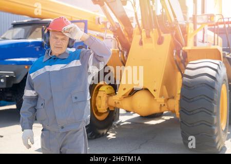 Driver yellow big truck on coal at open pit mining. Concept industry man worker. Stock Photo