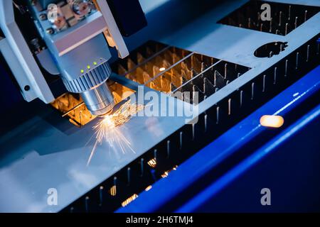 Laser CNC cut of metal with light spark Blue color, technology industrial modern. Stock Photo