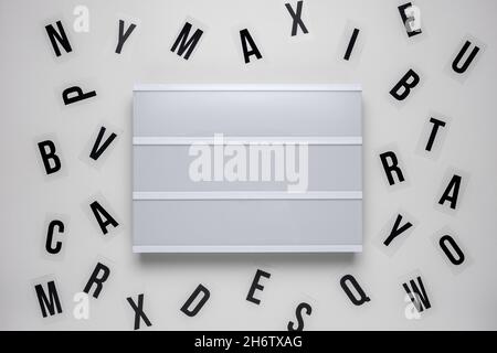 Blank lightbox with letters over white background. Stock Photo